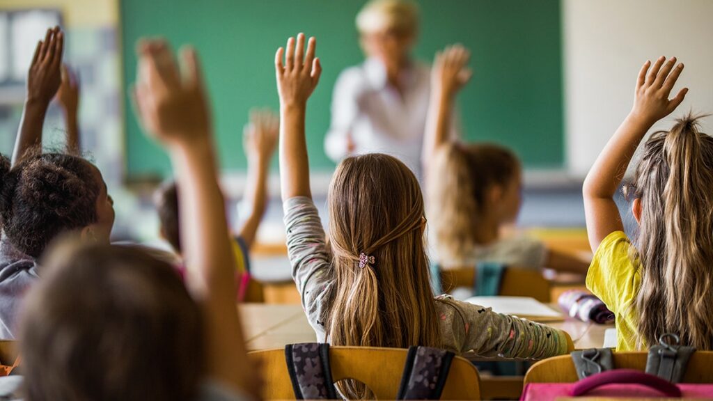 children-raise-hands-classroom-school.jpg