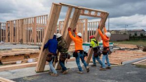 home-construction-workers-lifting-beams-getty.jpg
