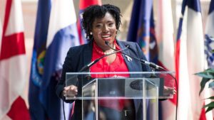 joanna-mcclinton-speaks-at-podium.jpgve1tl1