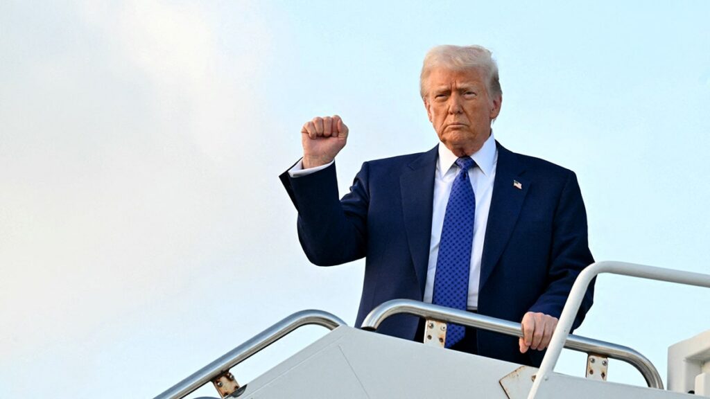 trump-holds-out-fist-after-stepping-off-air-force-one-at-palm-beach-international-airport-february-2025.jpgve1tl1